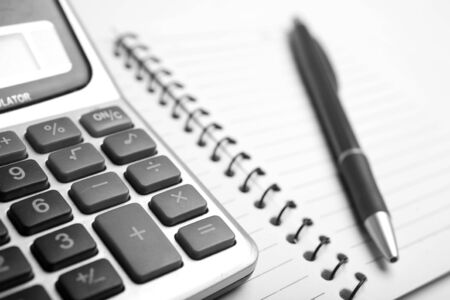 Close up calculator, notebook and pen monochrom colorの写真素材