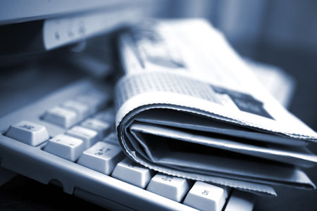 Newspapers on the computer keyboard close up