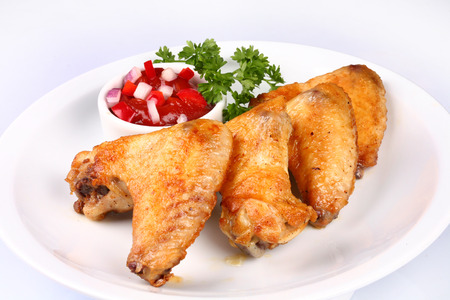 Plate of chicken wings and vegetablesの写真素材