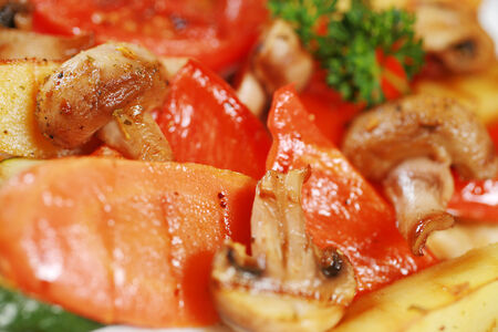 Grilled vegetables and mushrooms served on a plateの写真素材