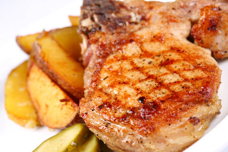 Grilled beefsteak with potatoes on whiteの写真素材
