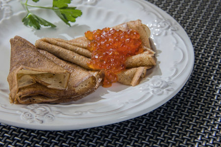 Russian cuisine- pancakes with red caviar on a plate.の写真素材