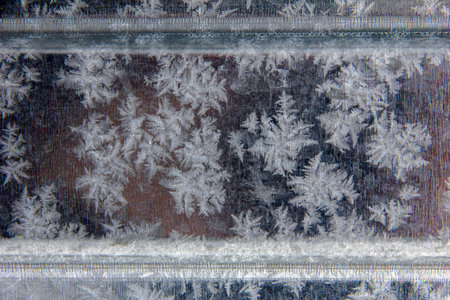 Patterns of natural frost and snowflakes on a metall