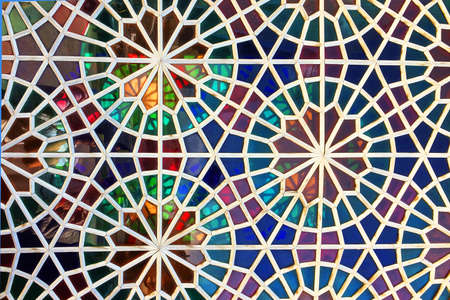 Handicraft stained glass window made of multi-colored glasses, various geometric shapesの写真素材