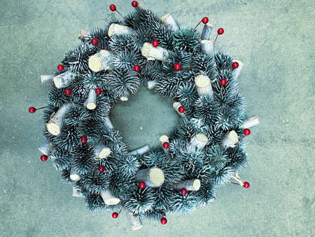 Christmas wreath made of pine cones on a concrete background, horizontal photo in cold silver colorsの写真素材