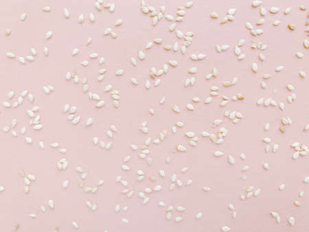 Pattern of white sesame seeds, pink delicate backgroundの写真素材