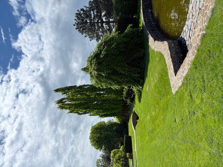 Garden stone path with garden design elements nearby. Fragment of a botanical garden.の写真素材