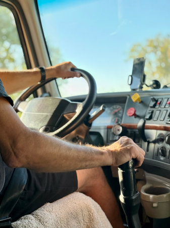 truck driver steers the vehicle with both mittened gloves hands on the steering wheelの写真素材