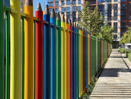 Close up multi colored fence in the form of large colored pencils. School concept. Copy spaceの写真素材