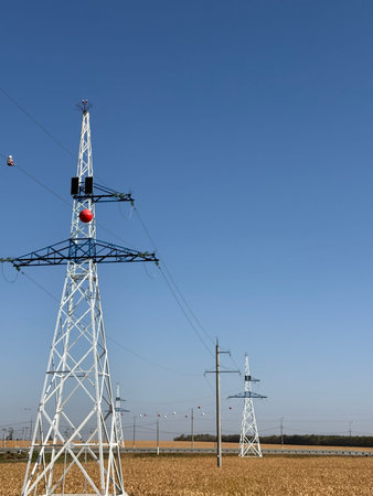 colored plastic balls hanging on overhead electricity wires are called aerial marker balls, viisual...