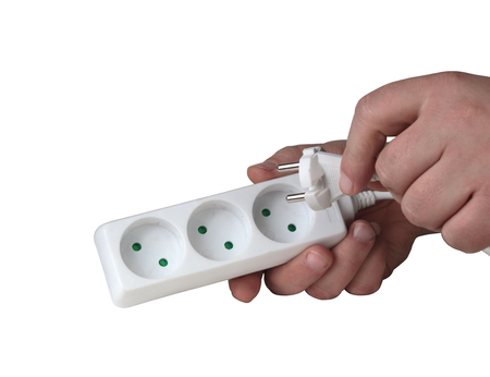 white electric splitter in a hand on a white backgroundの写真素材