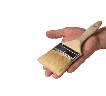brush in hand on a white backgroundの写真素材