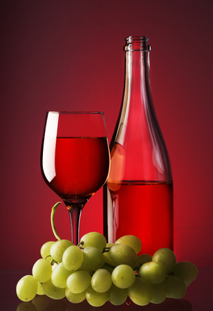 a bottle of wine with a chalice and grapesの写真素材