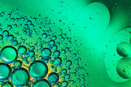oil bubbles with water on glass and colored background