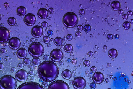 oil bubbles with water on a colored backgroundの写真素材