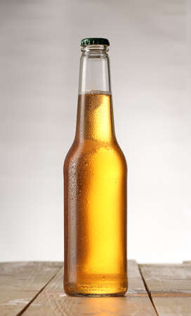 full bottle of light beer on a white backgroundの写真素材