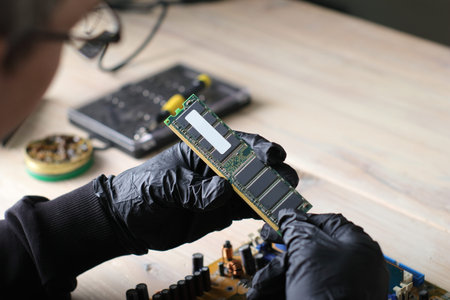 inserting ram into motherboard from computer on table and gray backgroundの写真素材