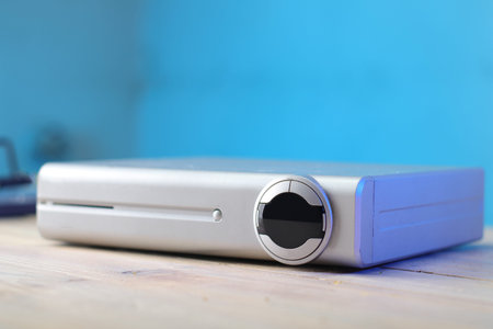 digital satellite tv tuner on table and colored background