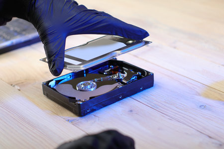 closing a computer disk on a table by a person wearing gloves