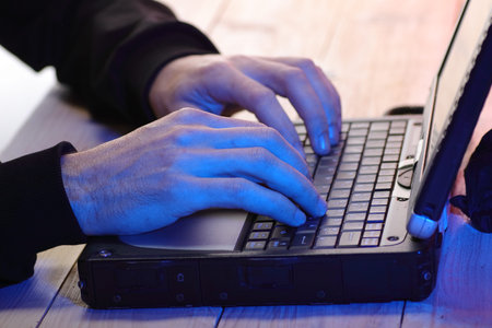 person typing on laptop keyboard on table