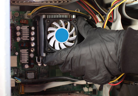 replacement of the cpu fan in the computer by the person on the tableの写真素材