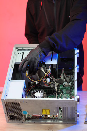 disassembly of an old desktop computer on a table and a pink backgroundの写真素材