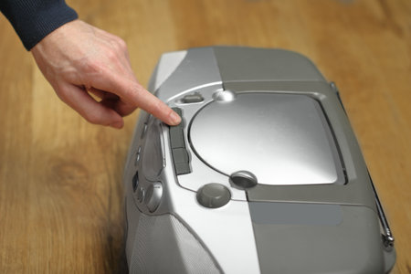 person presses cassette drawer opening button in cd playerの写真素材