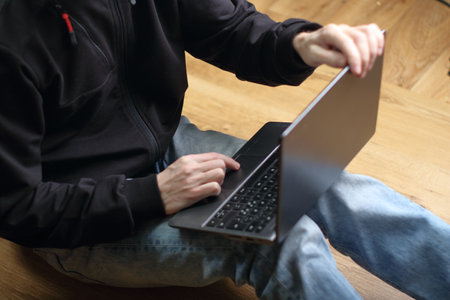 person is typing on a laptop keyboardの写真素材