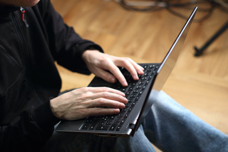 person is typing on a laptop keyboardの写真素材