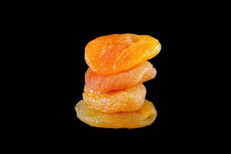 Dried apricots on a black background の写真素材