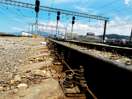railroad tracks taken from a low angle, with houses in the backgroundの写真素材