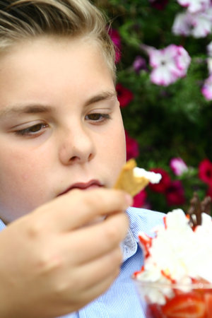 portrait of an young boy, eating ice and fruits, cup of ice and fruits,