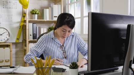 young girl interior designer using ruler and pen measure length of shelf. woman architect gauge...