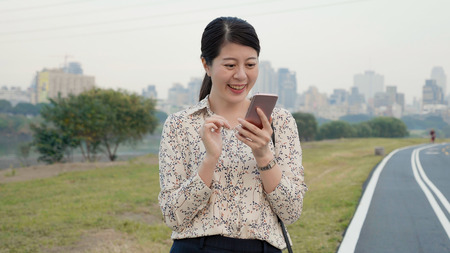 young female start up business woman receive invite message for New York Fashion Week.の写真素材