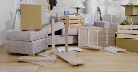 living room of new home with flat pack diy assemble furniture and cardboard boxes.