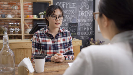 Job interview candidate listen to recruiter in cafe shop. concentrated nervous asian woman applicant...