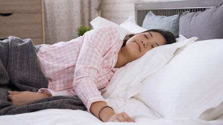 portrait of korean young woman lying on side is having a sweet dream at daytime. wellbeing, sleep...