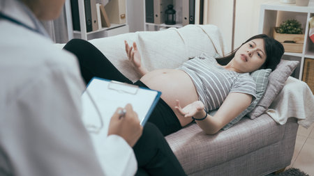 Psychological help concept. unhappy young asian pregnant woman telling problem to psychologist while...