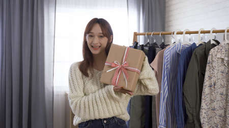 live streamer selling garments online and announcing free christmas present wrapping service.の写真素材