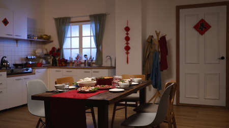 interior of a dining room with reunion dinner and festive decoration in celebration of lunar new year at home. chinese character on door meaning âspring.âの写真素材