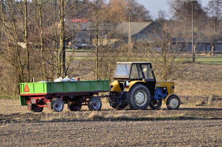 The photo shows a tractor during the spring field activities 