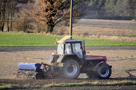 The photo shows a tractor during the spring field activities 
