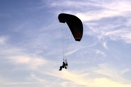 Photo shows a paraglider flies on a background of blue sky の写真素材