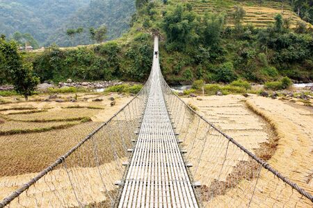 hanging footbridge in Nepal の写真素材