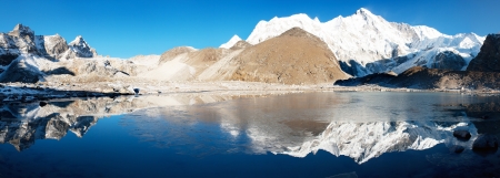 view of Cho Oyu mirroring in lake - Cho Oyu base camp - Everest trek - Nepal の写真素材