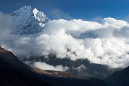 Thamserku peak, Phortse village and beautiful clouds - trek to Everest base camp - Nepalの写真素材