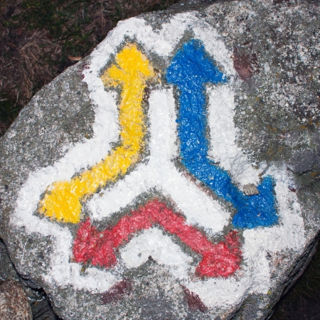 red yellow and blue hiking trail signs symbols on grey background の写真素材