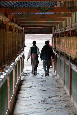 Tibetan people and prayer wheels, Labrang monastery, Xiahe, Chinaの写真素材