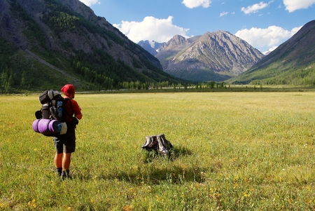 View from Altay range - Man with backpack on meadow - Karagem valley - Russiaの写真素材