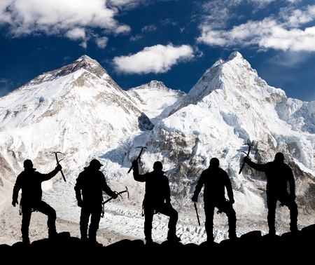 Silhouette of men with ice axe in hand, Mount Everest and Lhotse from Pumo Ri base camp - way to Everest base camp - Nepalの写真素材